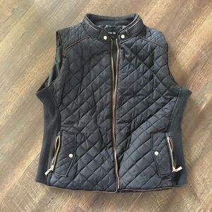 Black quilted vest with gold accents